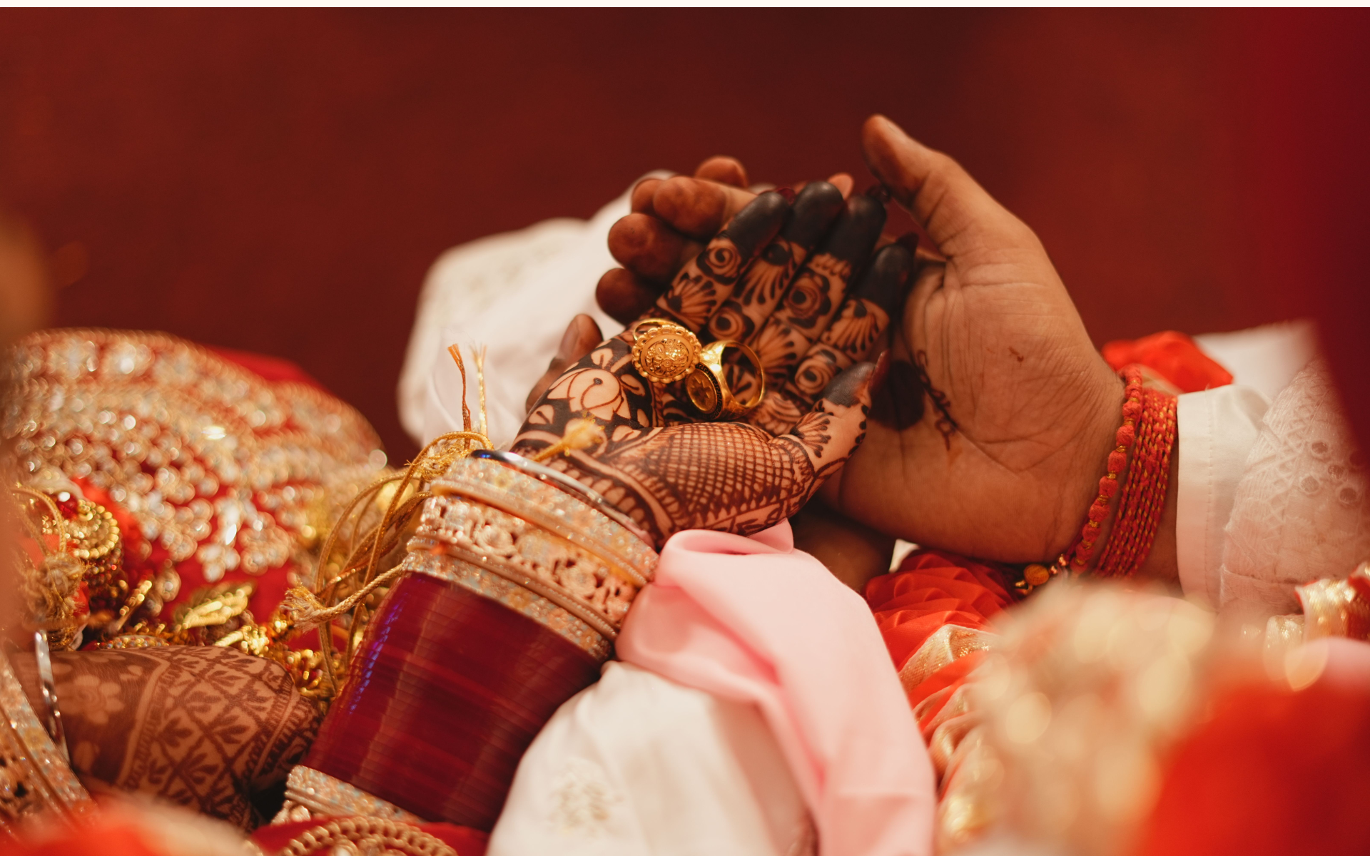 Bride and groom's hands joined during an Indian wedding ceremony